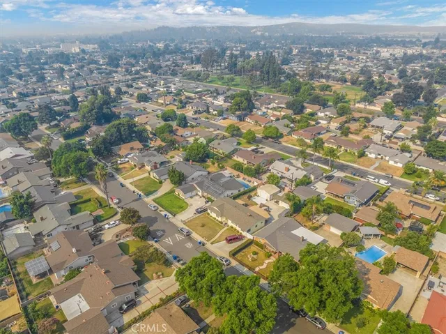 an aerial view of residential houses with yard