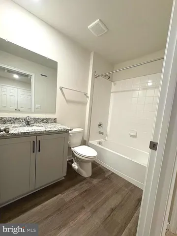 an empty room with a window and a bathroom