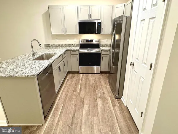 a kitchen with stainless steel appliances a refrigerator stove and sink