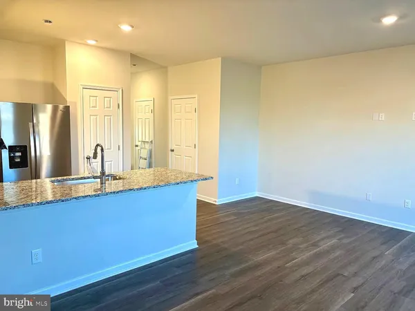 an empty room with wooden floor and window