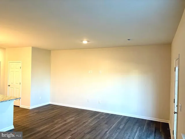 a view of a kitchen with wooden floor and a sink