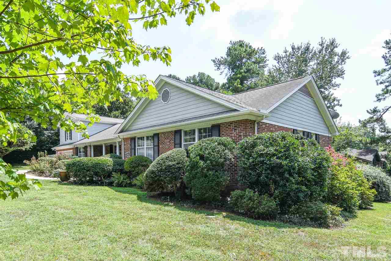 a view of a house with garden and yard