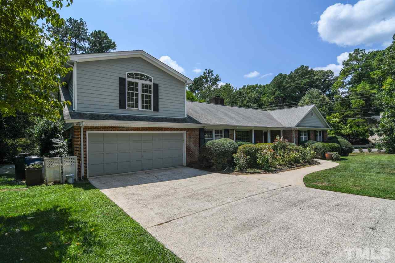 409 May Court Raleigh, NC 27609 - Photo 2 of 25 a front view of a house with a yard and garage