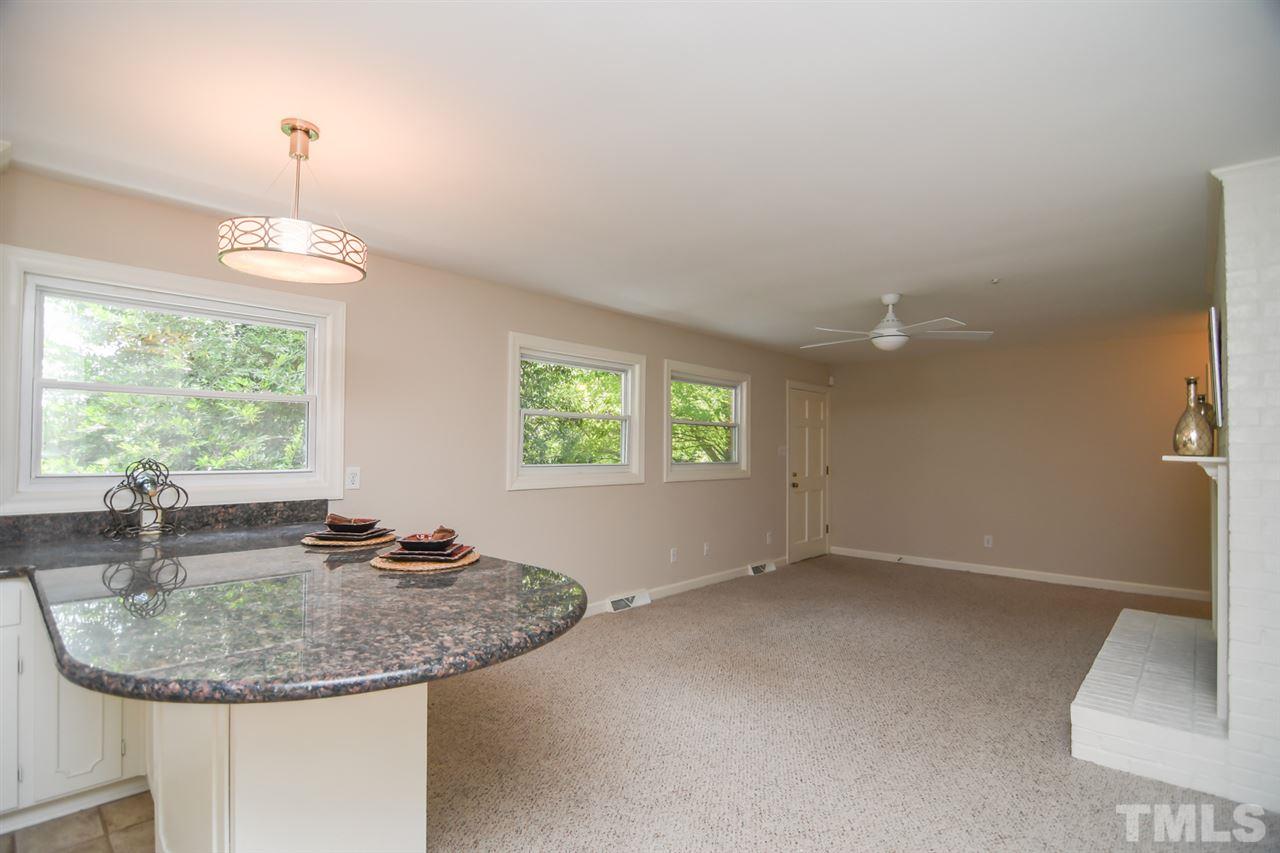 409 May Court Raleigh, NC 27609 - Photo 12 of 25 a dining room with a window and chandelier