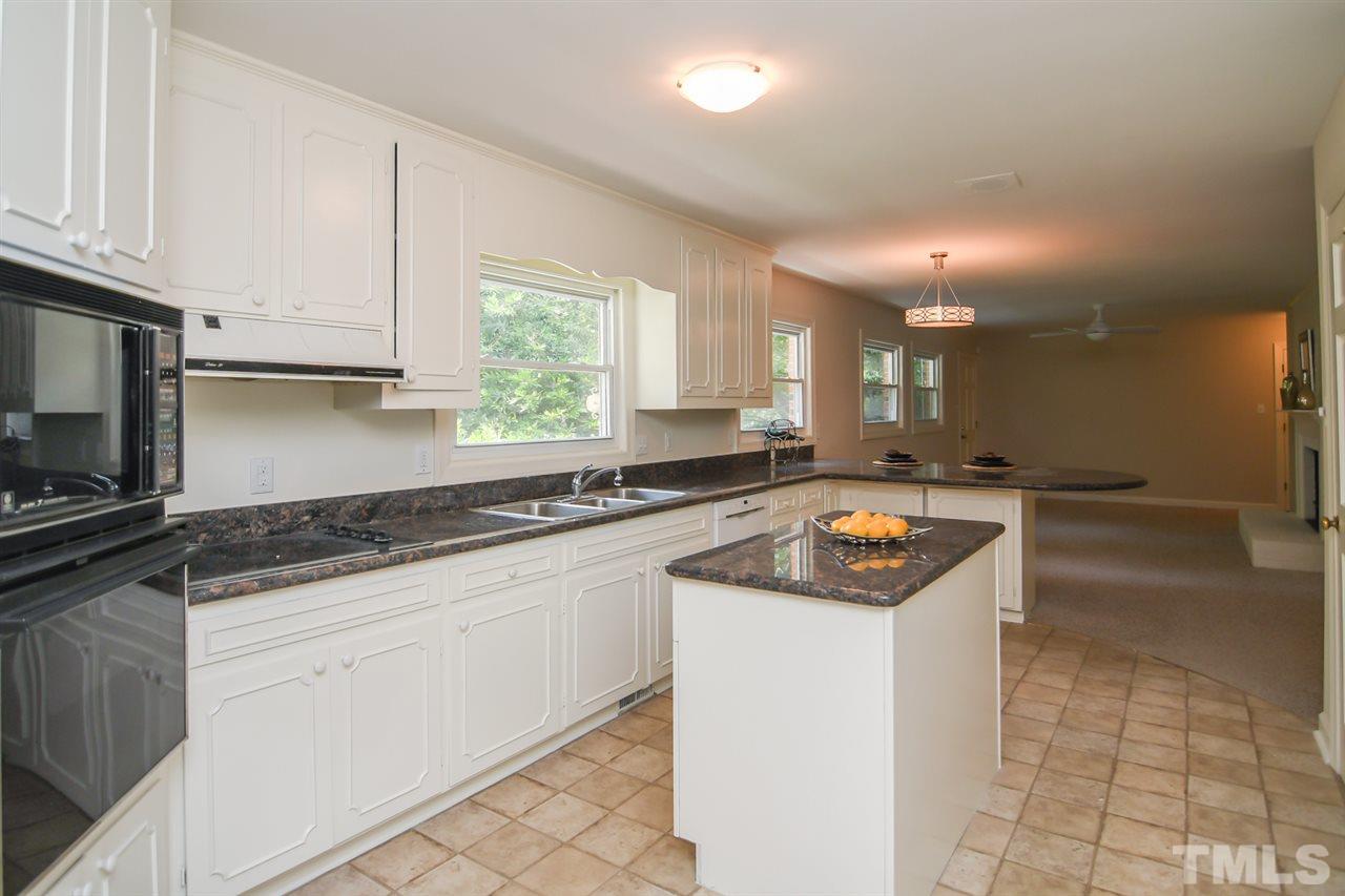 409 May Court Raleigh, NC 27609 - Photo 13 of 25 a kitchen with granite countertop white cabinets and white appliances