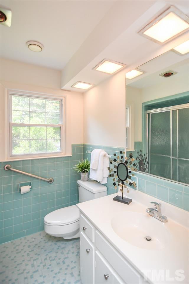 409 May Court Raleigh, NC 27609 - Photo 15 of 25 a bathroom with a sink a toilet and mirror