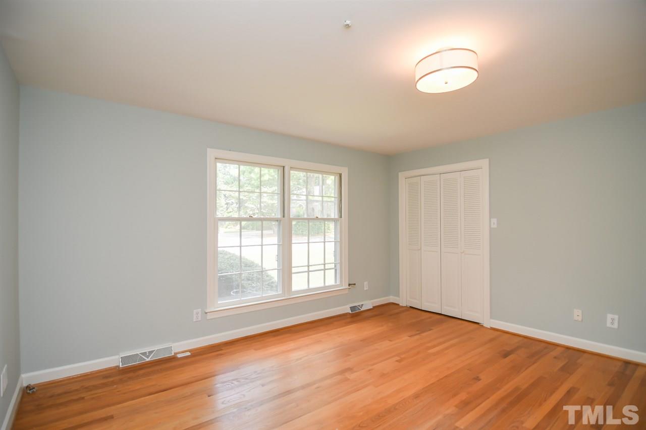 409 May Court Raleigh, NC 27609 - Photo 18 of 25 an empty room with wooden floor and windows