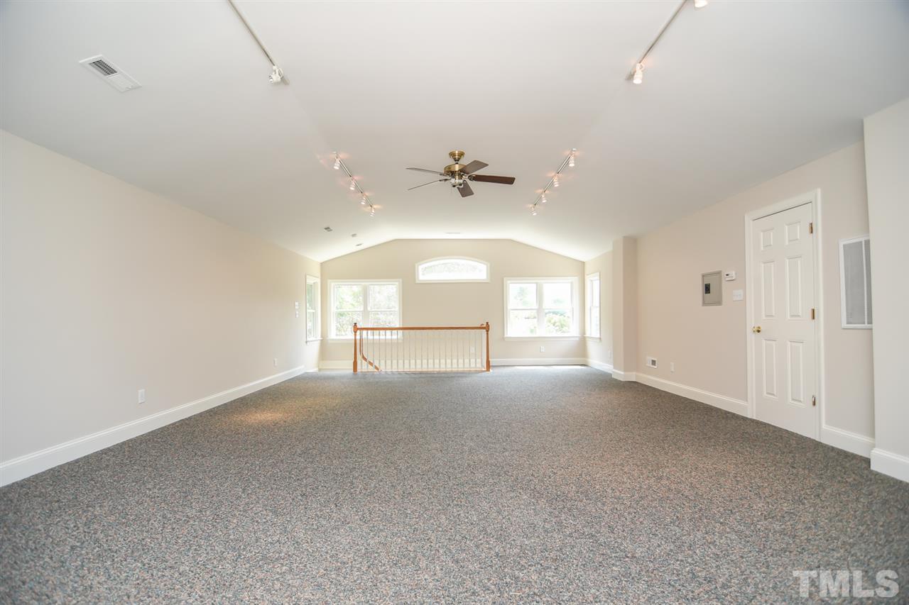 409 May Court Raleigh, NC 27609 - Photo 20 of 25 an empty room with a ceiling fan and window
