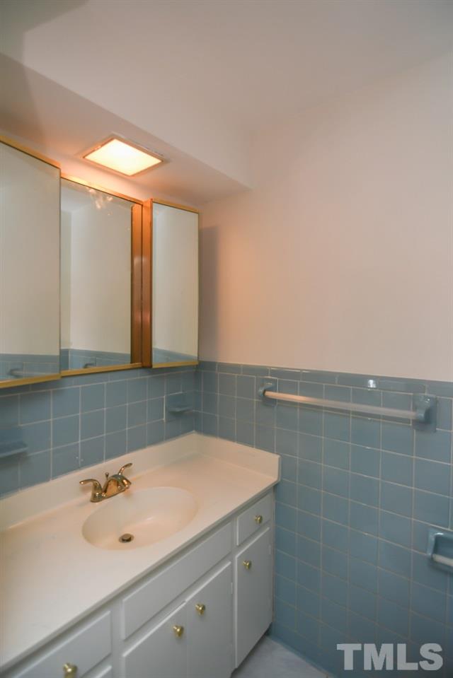 409 May Court Raleigh, NC 27609 - Photo 22 of 25 a bathroom with a sink and a mirror
