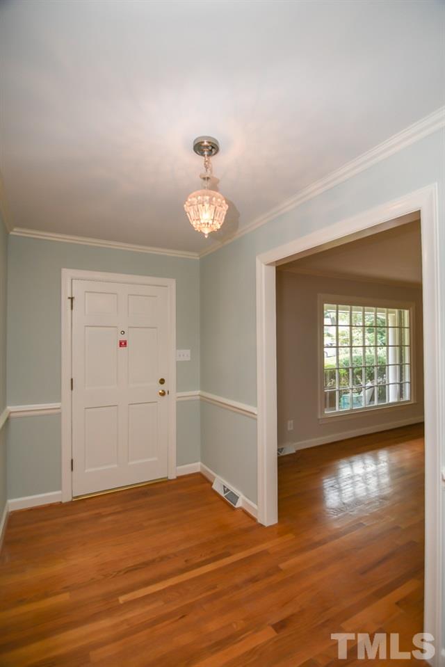409 May Court Raleigh, NC 27609 - Photo 5 of 25 a view of an empty room with window and wooden floor