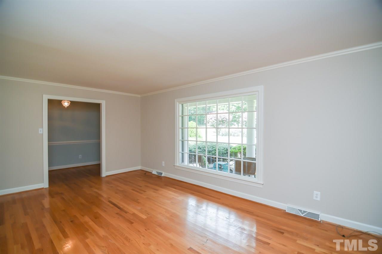 409 May Court Raleigh, NC 27609 - Photo 6 of 25 an empty room with wooden floor and windows