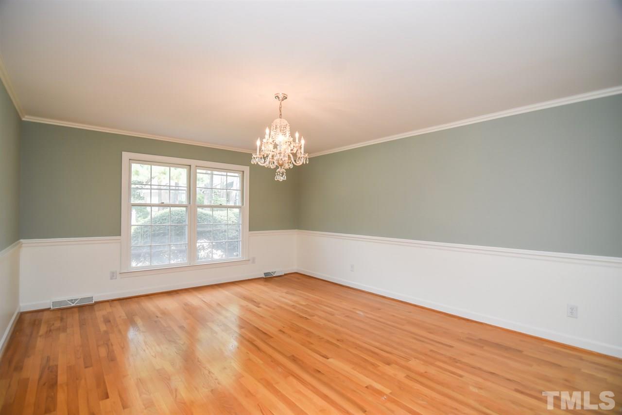 409 May Court Raleigh, NC 27609 - Photo 9 of 25 wooden floor in an empty room with a window