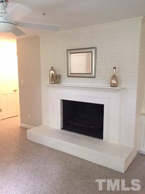 409 May Court Raleigh, NC 27609 - Photo 10 of 25 a living room with a fireplace and a table