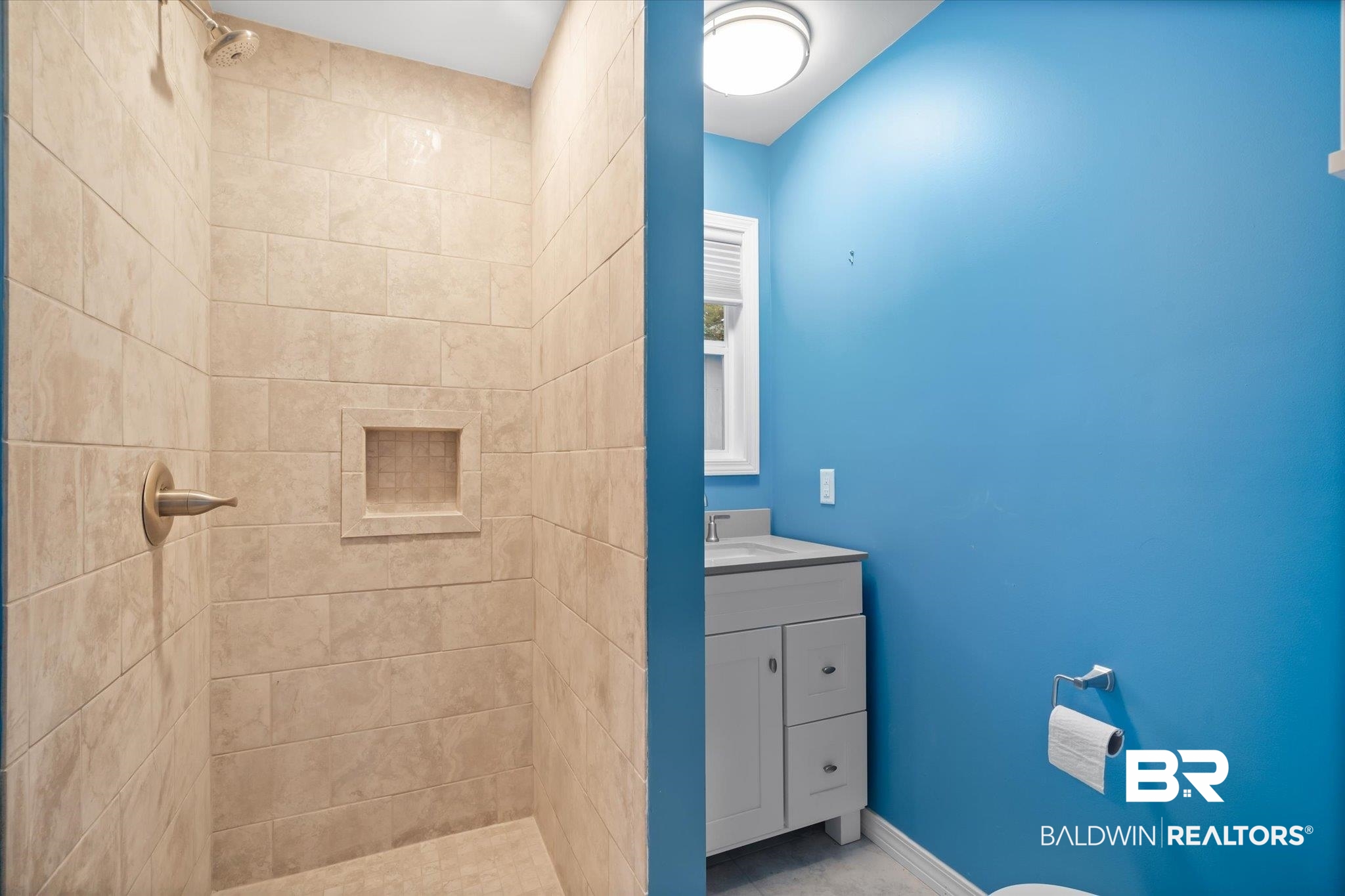 14 South Monterey Street Mobile, AL 36604 - Photo 24 of 41 Bathroom with toilet, vanity, and tiled shower