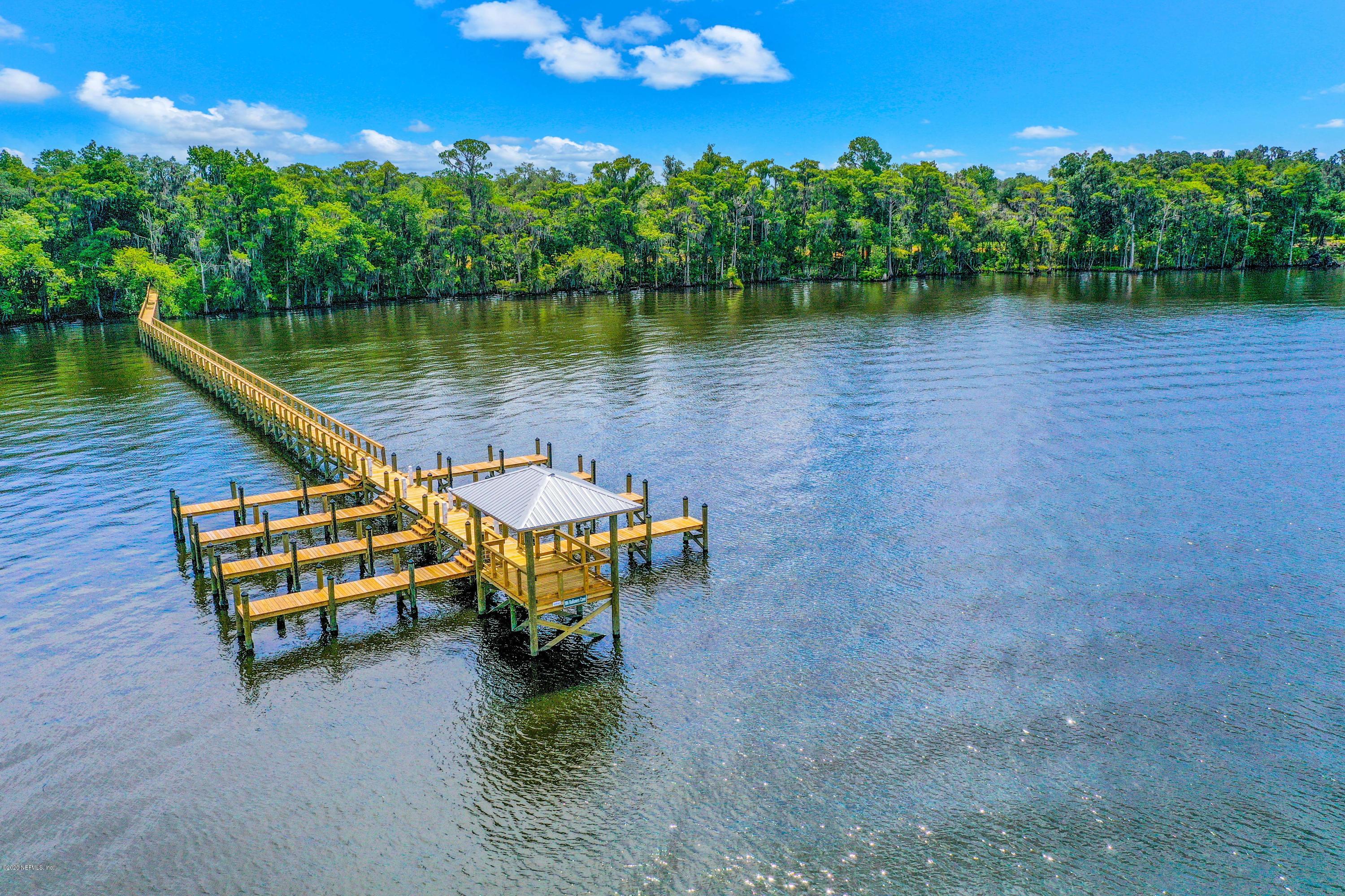 302 Hallowes Cove St. Johns, FL 32259 - Photo 2 of 14 a view of a lake with a bench in front of house