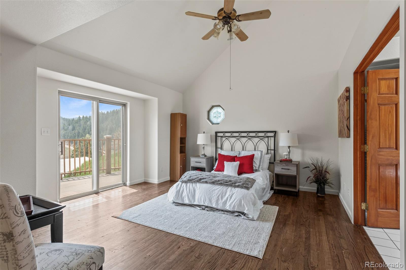 12183 Arnett Ranch Road Littleton, CO 80127 - Photo 14 of 28 a bedroom with a bed and wooden floor
