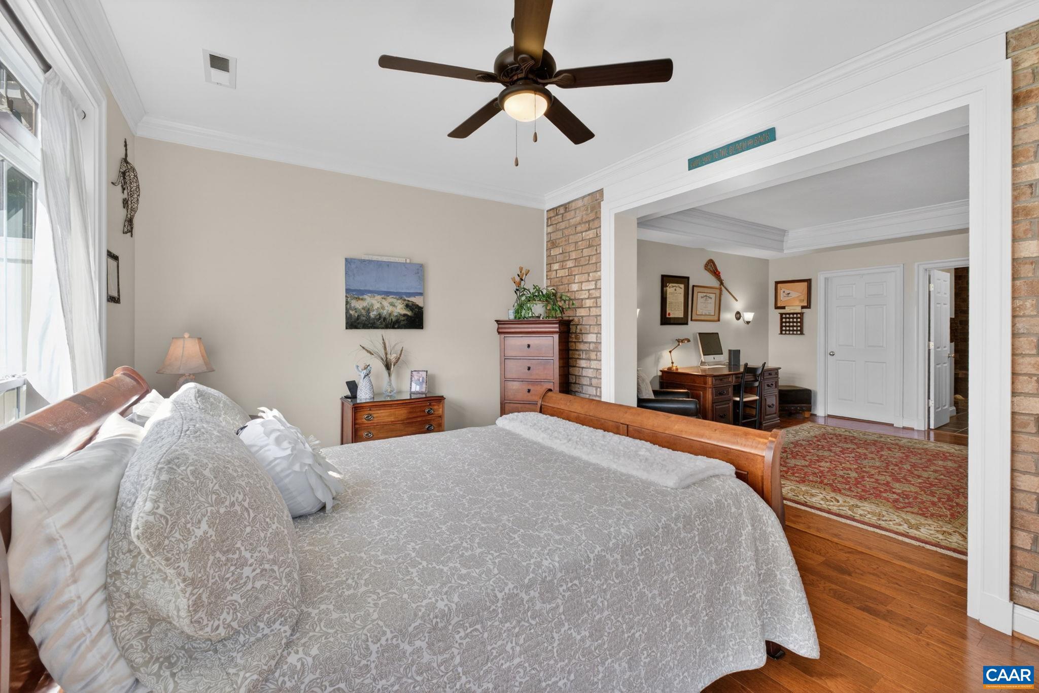 1338 Gate Post Lane Charlottesville, VA 22901 - Photo 25 of 50 a bedroom with a large bed and a chandelier