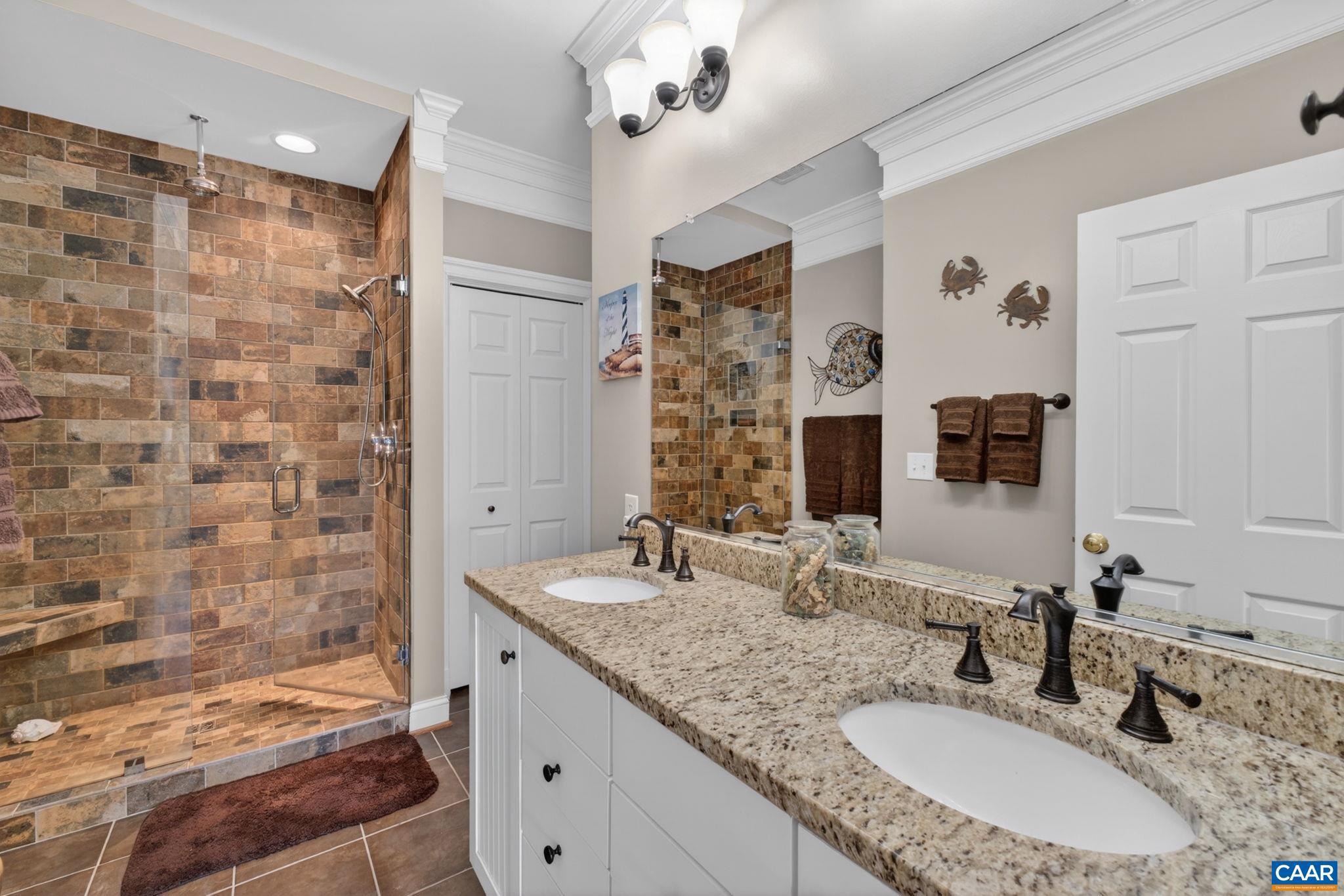 1338 Gate Post Lane Charlottesville, VA 22901 - Photo 29 of 50 a bathroom with a granite countertop double vanity sink a mirror and shower