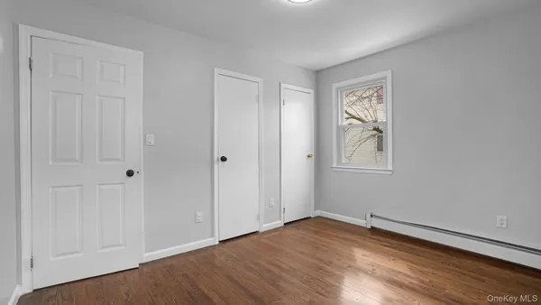 an empty room with windows and closet