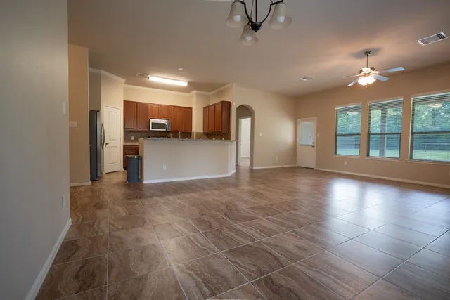 a view of a livingroom with furniture and chandelier fan