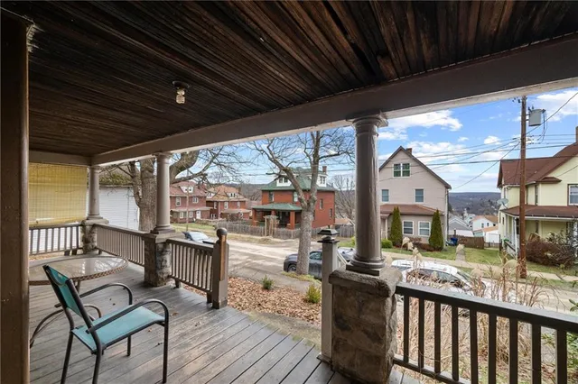 a view of a chairs and table in patio with a barbeque grill
