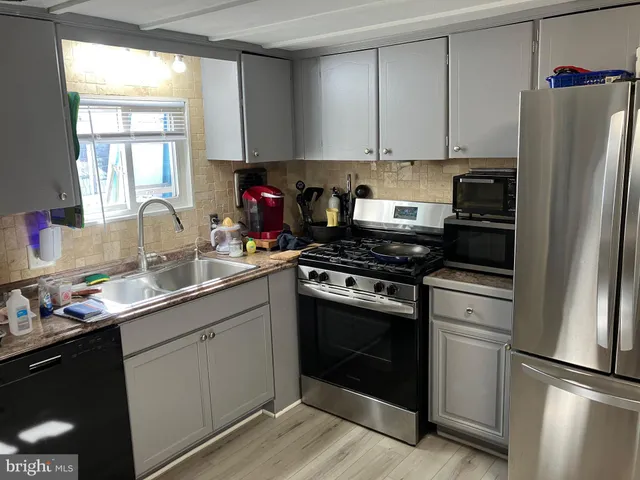 a kitchen with a refrigerator stove and sink
