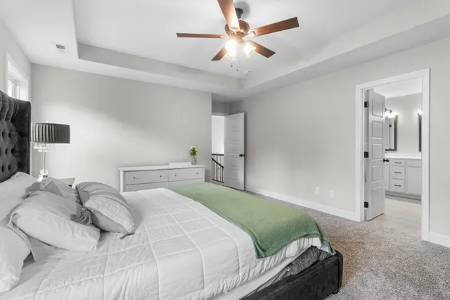 a bedroom with a bed and a chandelier