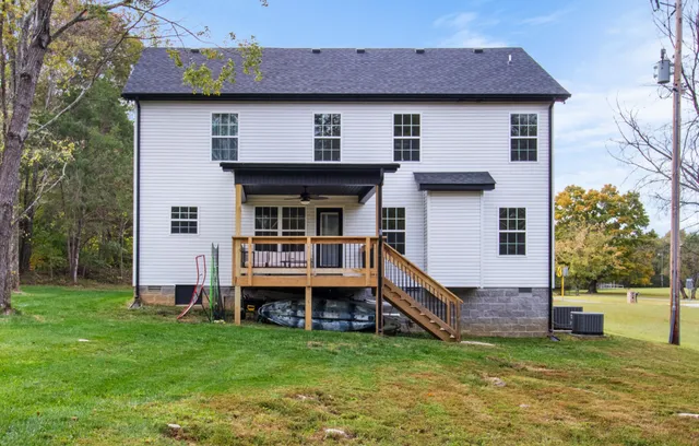 an aerial view of residential houses with outdoor space and trees