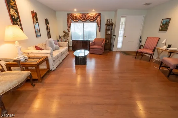 a living room with fireplace furniture and a wooden floor