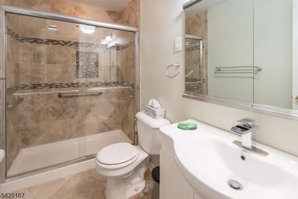 a bathroom with a sink toilet and shower
