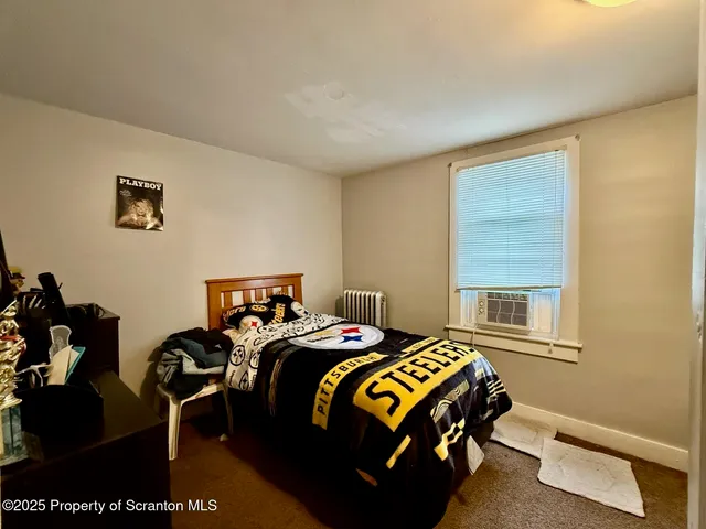 a bedroom with a bed and a desk