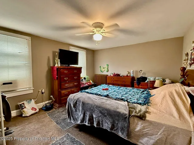 a bedroom with two beds and a flat screen tv