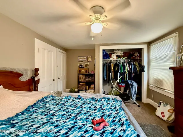 a bedroom with bed and a chandelier