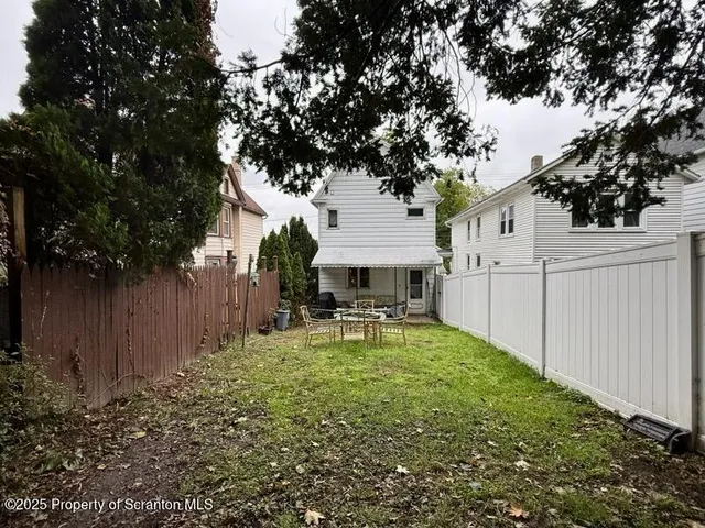 a view of a house with backyard porch and sitting area