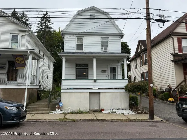 a view of a white house with large windows
