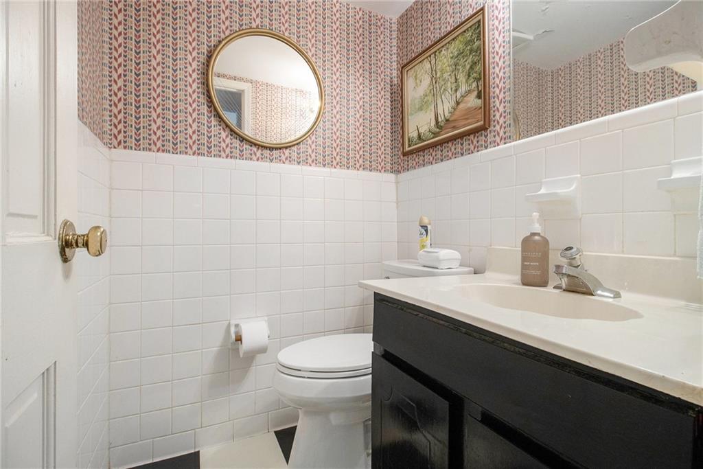 2367 Henderson Mill Road, Unit 8 Atlanta, GA 30345 - Photo 13 of 35 a bathroom with a toilet a sink and mirror