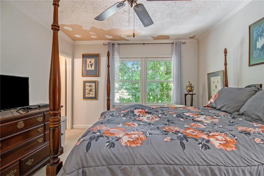 2367 Henderson Mill Road, Unit 8 Atlanta, GA 30345 - Photo 15 of 35 a bedroom with a bed and a flat tv screen