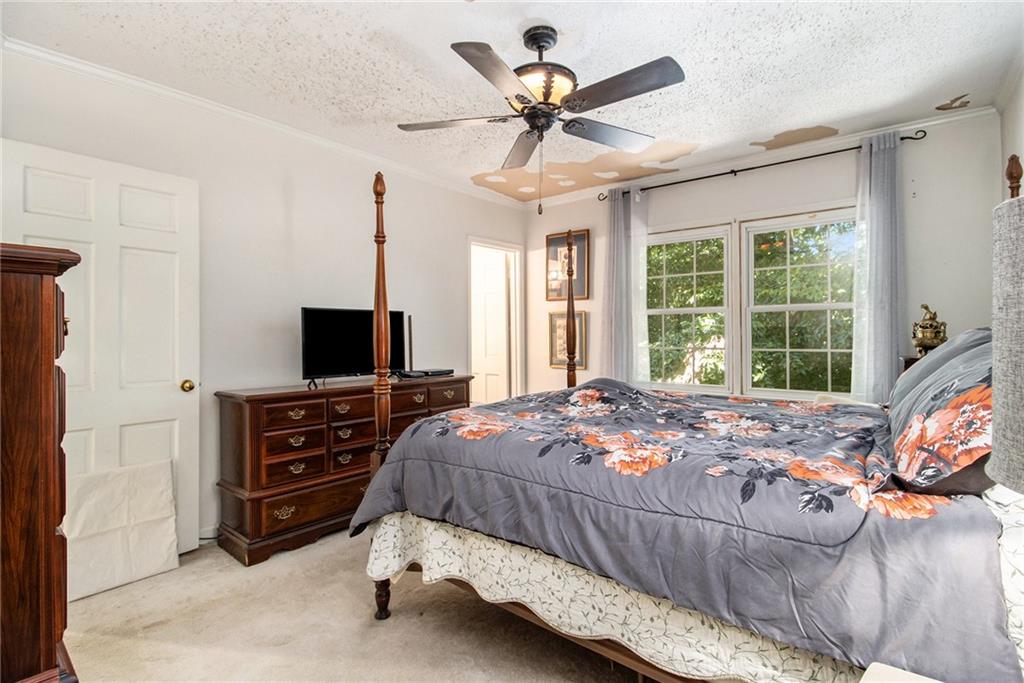 2367 Henderson Mill Road, Unit 8 Atlanta, GA 30345 - Photo 16 of 35 a bedroom with a bed and a flat screen tv