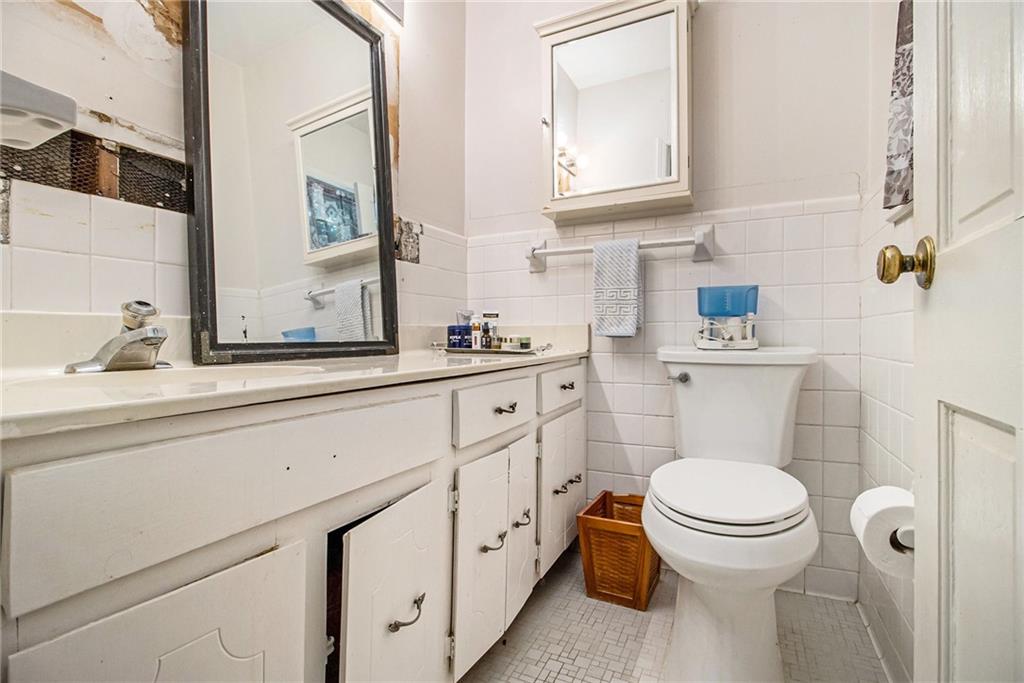 2367 Henderson Mill Road, Unit 8 Atlanta, GA 30345 - Photo 18 of 35 a bathroom with a granite countertop toilet sink and mirror