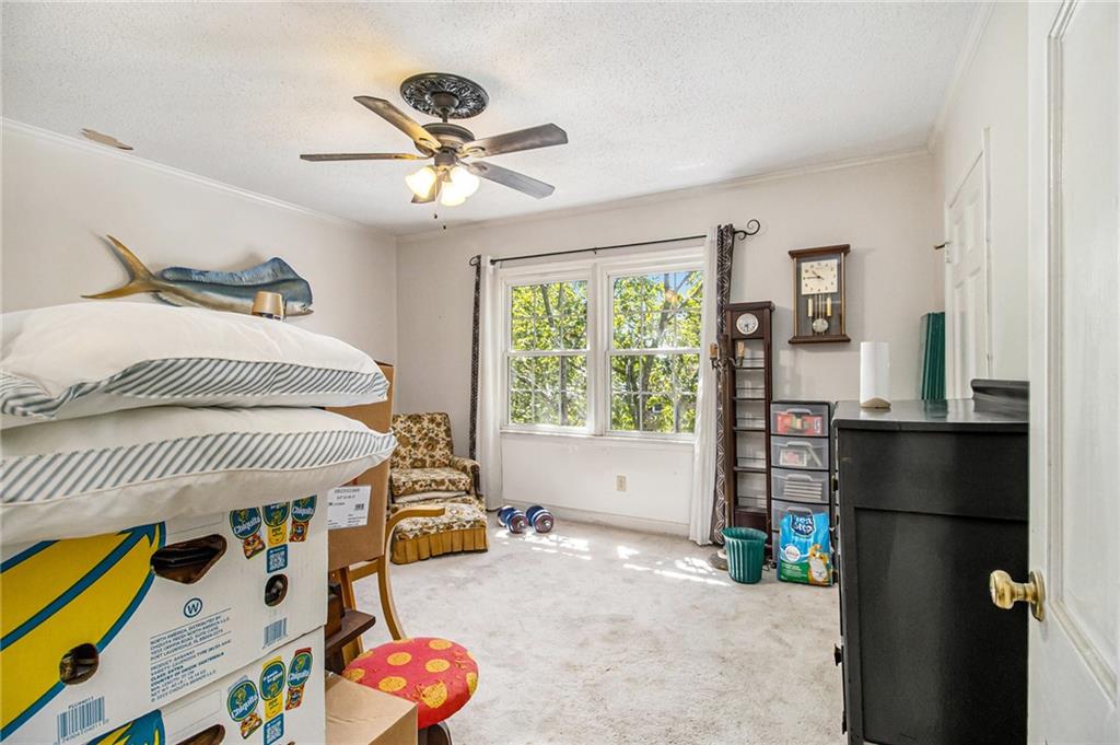 2367 Henderson Mill Road, Unit 8 Atlanta, GA 30345 - Photo 21 of 35 a bedroom with a bed and a chandelier