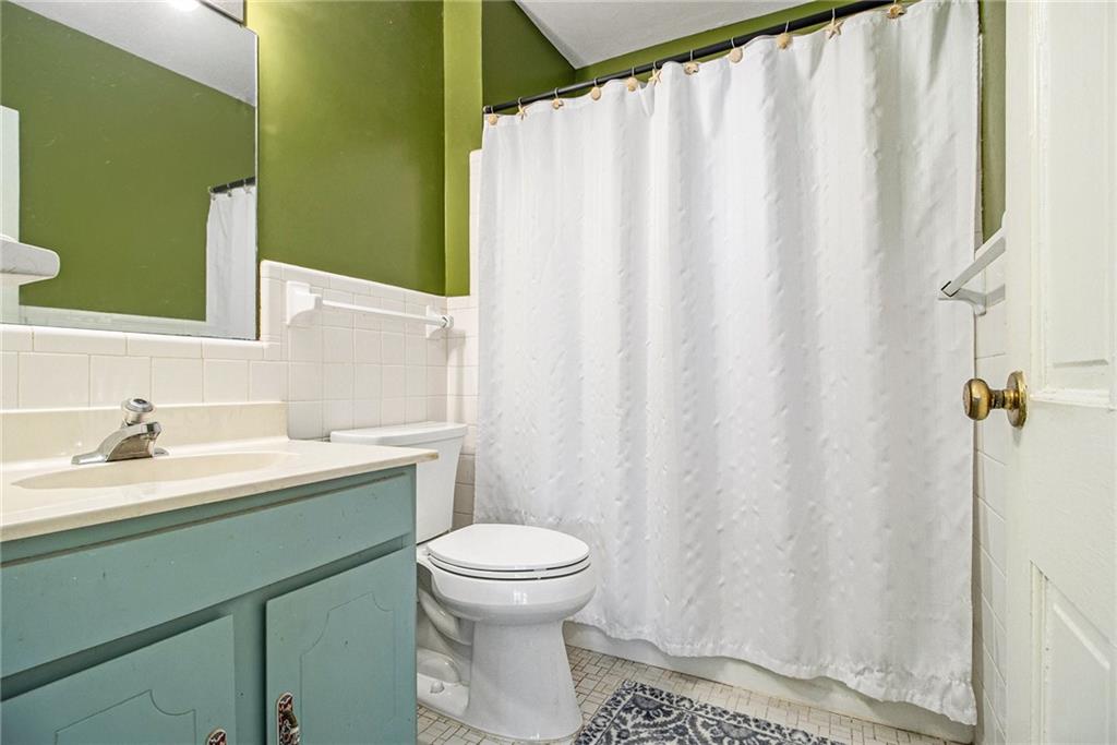 2367 Henderson Mill Road, Unit 8 Atlanta, GA 30345 - Photo 24 of 35 a bathroom with a sink a toilet and a mirror