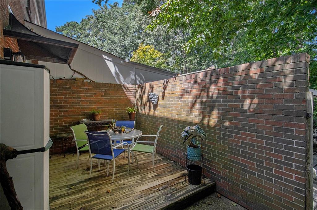 2367 Henderson Mill Road, Unit 8 Atlanta, GA 30345 - Photo 26 of 35 a patio with table and chairs and potted plants