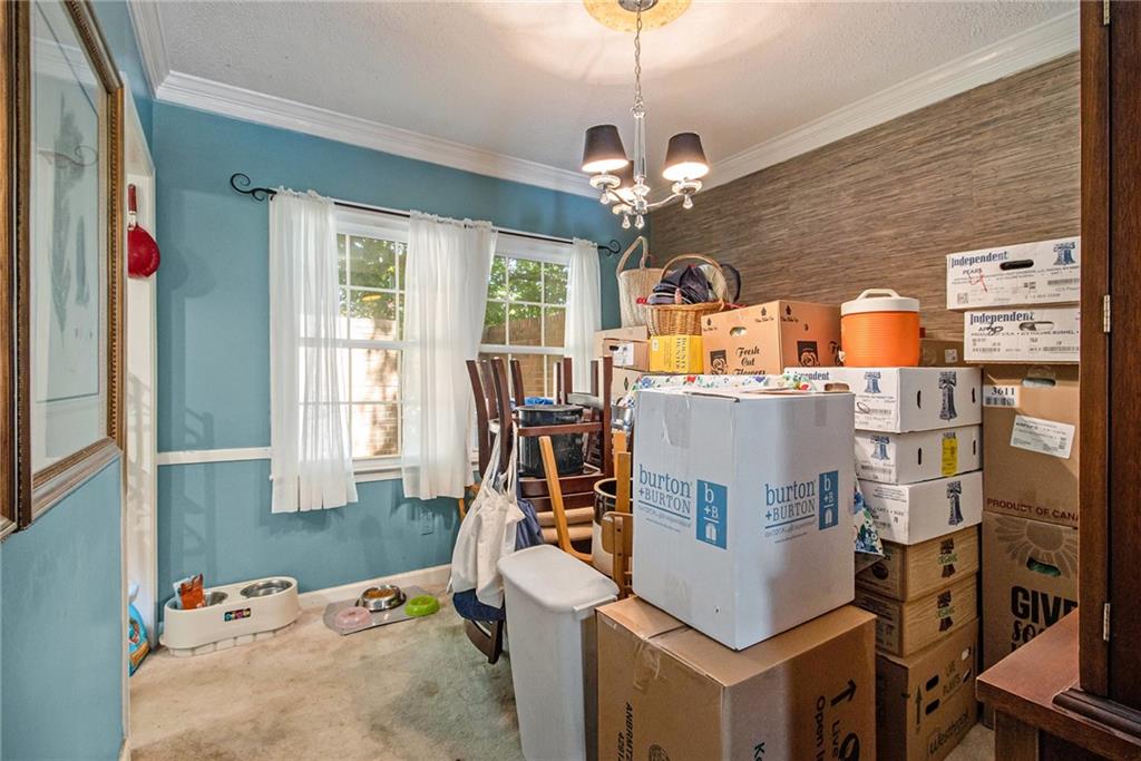 2367 Henderson Mill Road, Unit 8 Atlanta, GA 30345 - Photo 8 of 35 a view of a dining room with furniture a chandelier and wooden floor