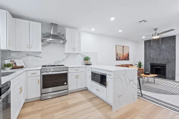 a kitchen with a refrigerator sink and cabinets