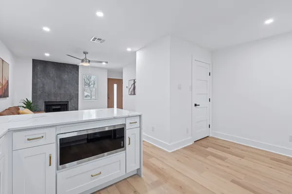 a kitchen with granite countertop a white stove top oven and cabinets