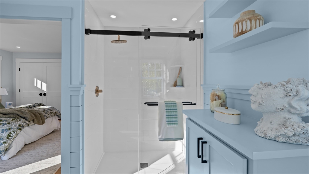 39 Connection Street Newport, RI 02840 - Photo 16 of 40 a bathroom with a tub sink and shower curtain