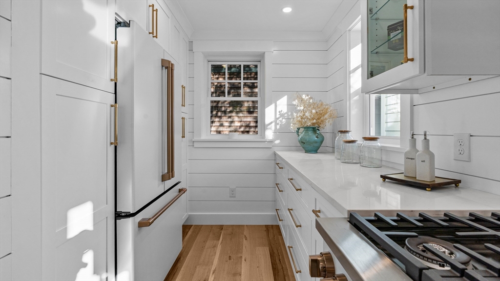 39 Connection Street Newport, RI 02840 - Photo 22 of 40 a kitchen with white cabinets and appliances