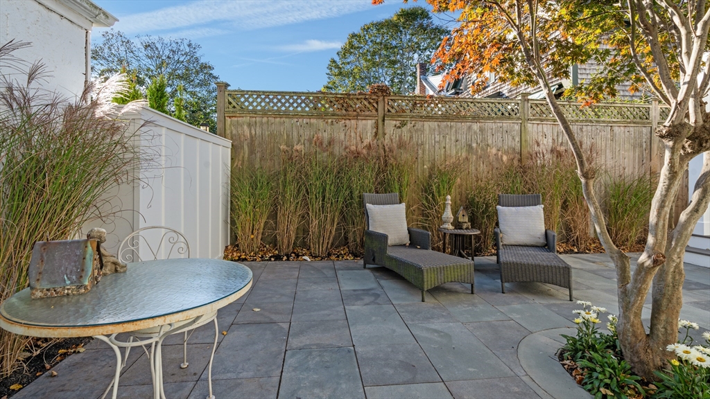 39 Connection Street Newport, RI 02840 - Photo 27 of 40 a view of backyard with table and chairs and a large tree