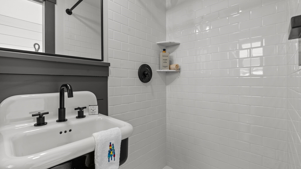 39 Connection Street Newport, RI 02840 - Photo 37 of 40 a bathroom with a sink and a mirror