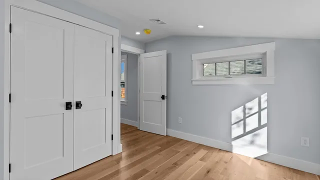 a view of an empty room and wooden floor
